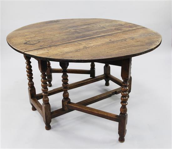 An early 18th century oak oval gate leg table, extended 4ft